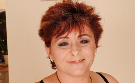 Inviting grandma Hetera in sexy underwear reveals big boobs and shaved pussy 