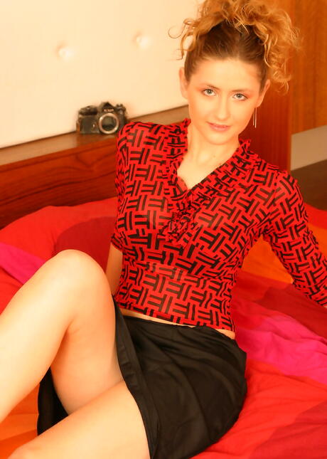 Sylphlike young Eva in sexy skirt shows big knockers and spreads her legs 